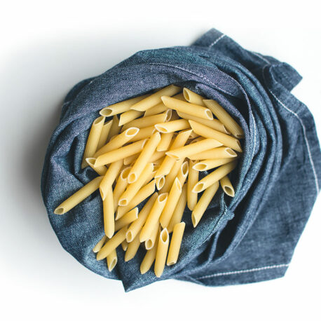 foodiesfeed.com_pasta-penne-in-blue-linen-on-a-white-background